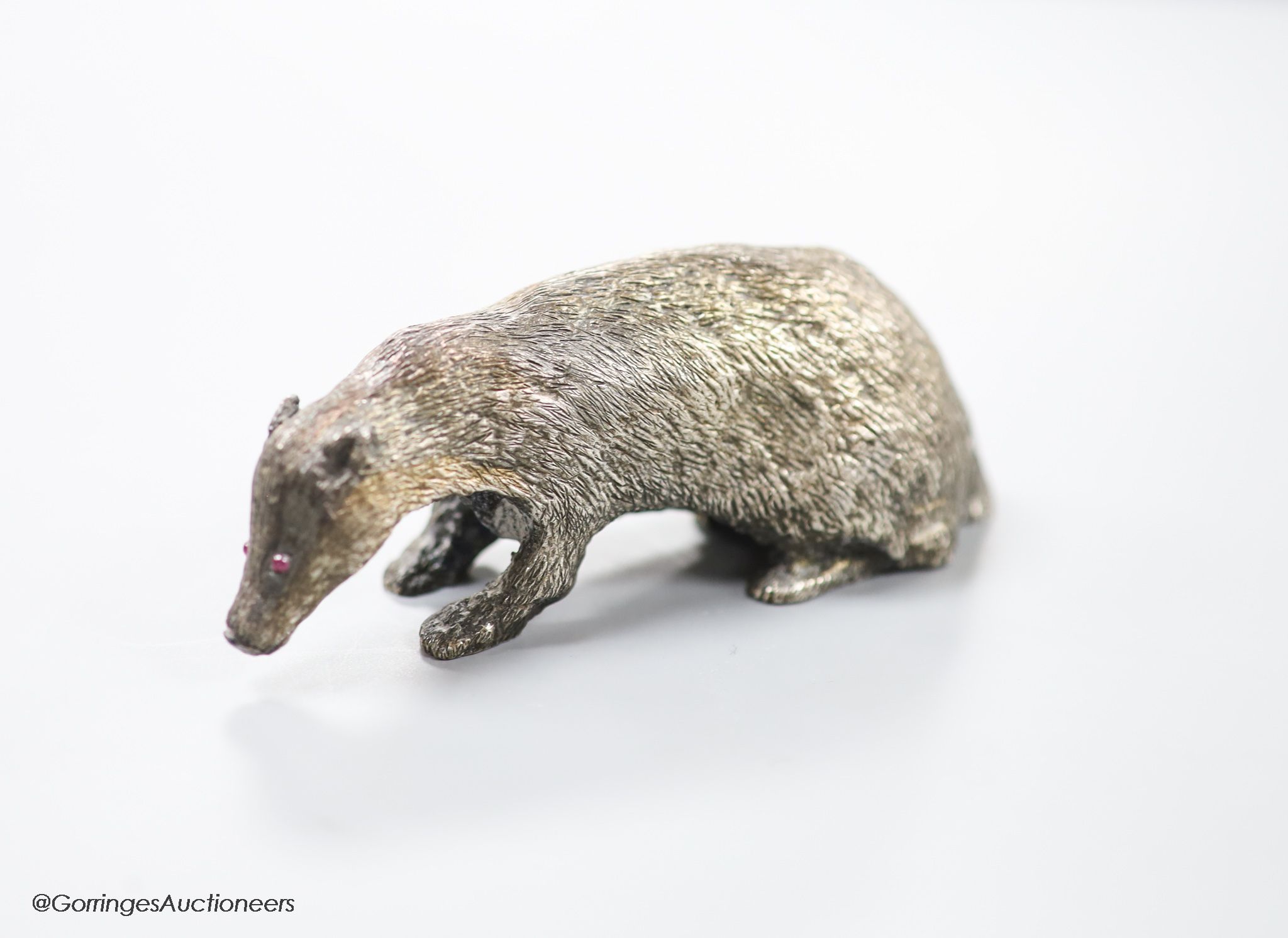 A modern free standing miniature model of a badger, with cabochon eyes, C.F.H & Co, London, 1992, length 10cm, 142 grams.